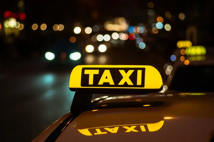 Excel Taxi Yeovil taxi sign at night ready for an early-morning airport run